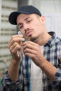 young male electrician standing in front fusebox Royalty Free Stock Photo
