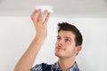 Male Electrician Testing Smoke Detector