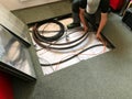 Electrician removes floor panels to get to cables