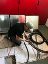 Electrician removes floor panels to get to cables