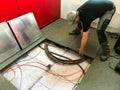 Electrician removes floor panels to get to cables