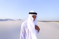 Young male emirate rejoices in life and walks through expanses o