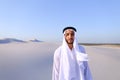 Young male emirate rejoices in life and walks through expanses o