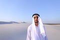 Young male emirate rejoices in life and walks through expanses o