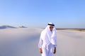 Young male emirate rejoices in life and walks through expanses o