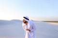 Young male emirate suffers from severe pains in abdomen, standin Royalty Free Stock Photo