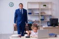 Young male employee and his little girl in the office Royalty Free Stock Photo