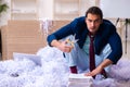 Young male employee and a lot of cut papers in the office Royalty Free Stock Photo