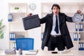 Young male employee in the office in time management concept Royalty Free Stock Photo