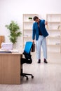 Young male employee in oversleeping concept Royalty Free Stock Photo