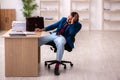 Young male employee in oversleeping concept Royalty Free Stock Photo