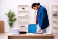 Young male employee in oversleeping concept Royalty Free Stock Photo