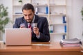 Young male employee playing cards at workplace Royalty Free Stock Photo