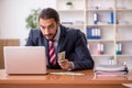 Young male employee playing cards at workplace Royalty Free Stock Photo