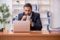 Young male employee playing cards at workplace Royalty Free Stock Photo