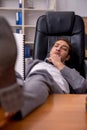 Young male employee sleeping at workplace Royalty Free Stock Photo