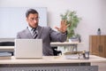 Young male employee with snake in the office Royalty Free Stock Photo