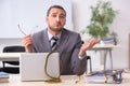 Young male employee with snake in the office Royalty Free Stock Photo