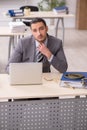 Young male employee with snake in the office Royalty Free Stock Photo