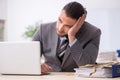 Young male employee with snake in the office Royalty Free Stock Photo