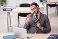 Young male employee with snake in the office Royalty Free Stock Photo