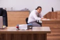 Young male employee stapling paper in the office Royalty Free Stock Photo