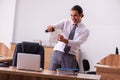 Young male employee stapling paper in the office Royalty Free Stock Photo