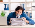 Young male employee with tape on the mouth