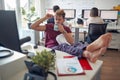A young male employee is too relaxed at the job in the office. Employees, job, office Royalty Free Stock Photo