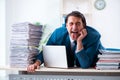 Young male employee unhappy with excessive work Royalty Free Stock Photo