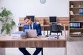 Young male employee unhappy with excessive work Royalty Free Stock Photo