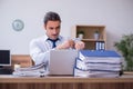 Young male employee unhappy with excessive work Royalty Free Stock Photo