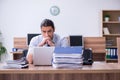 Young male employee unhappy with excessive work Royalty Free Stock Photo