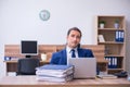 Young male employee unhappy with excessive work Royalty Free Stock Photo