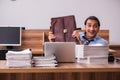 Young male employee unhappy with excessive work Royalty Free Stock Photo