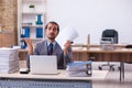 Young male employee unhappy with excessive work in the office Royalty Free Stock Photo