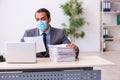 Young male employee wearing mask during pandemic Royalty Free Stock Photo