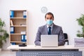 Young male employee wearing mask during pandemic Royalty Free Stock Photo