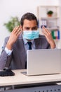 Young male employee wearing mask during pandemic Royalty Free Stock Photo
