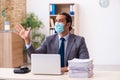 Young male employee wearing mask during pandemic Royalty Free Stock Photo