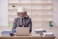 Young male employee wearing spacesuit in the office