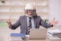 Young male employee wearing spacesuit in the office