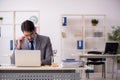 Young male employee working in the office Royalty Free Stock Photo