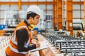 Young male engineer supervisor working QC in metal sheet manufactory work checking production line