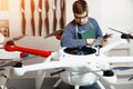Young Male Engineer or Technician with Holding Tablet in His Hands Programs Drone. Royalty Free Stock Photo