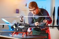 Young Male Engineer or Technician with Remote Control in His Hands Programs Drone. Royalty Free Stock Photo