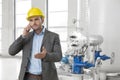 Young male engineer using cell phone in industry Royalty Free Stock Photo