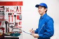 Young male engineer at work in mechanic tools storage room Royalty Free Stock Photo