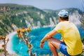 Young male enjoys Petani beach on Kefalonia. Highly excited picturesque panorama of emerald blue lagoon bay of