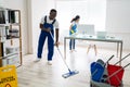 Male And Female Cleaners Cleaning Office Royalty Free Stock Photo